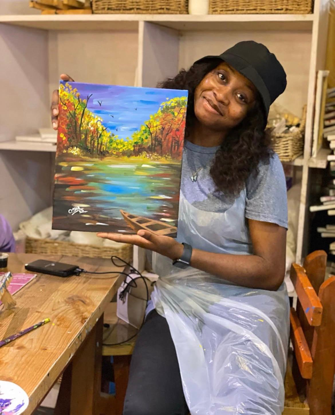 Salome holding one of her paintings